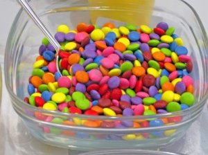 12370833-edible-color-small-sweets-heap-in-glass-container-sugar-food-details